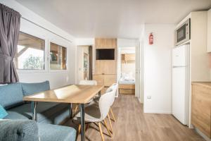 a kitchen and living room with a table and chairs at Camping Inntal in Wiesing