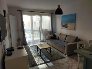 a living room with a couch and a table at Apartament Portowy z garażem, ul Towarowa in Kołobrzeg