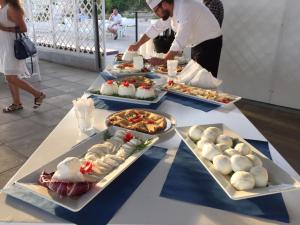 a table with several plates of food on it at Torre Del Sole in Terracina