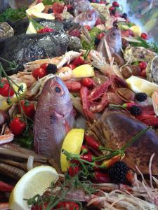 a pile of seafood and vegetables on a table at Torre Del Sole in Terracina