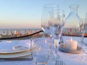 a table with two wine glasses and a candle at Torre Del Sole in Terracina