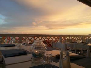 a table with glasses on top of a balcony at Torre Del Sole in Terracina