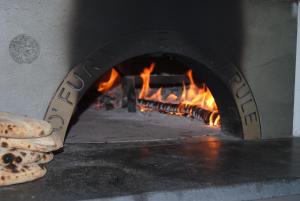 a pizza oven with a fire in it at Torre Del Sole in Terracina