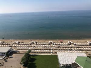 an aerial view of a beach with white umbrellas at Torre Del Sole in Terracina