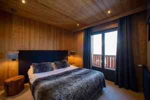 Posteľ alebo postele v izbe v ubytovaní Chalet Les Rhodos