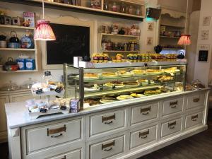 a display case in a bakery with many pastries at La Terrazza Di Arturo Guest House in Turin