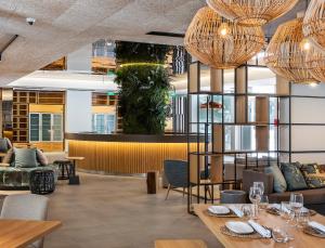 a restaurant with tables and chairs and chandeliers at The Patio Suite Hotel in Albufeira