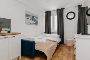 a bedroom with a bed and a clock on the wall at ShortStayPoland Pańska in Warsaw