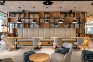 a restaurant with tables and chairs in a room at The Patio Suite Hotel in Albufeira