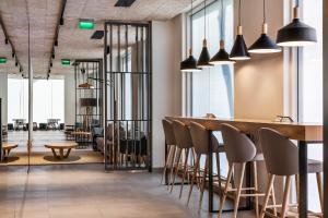 a bar in a restaurant with chairs and lights at The Patio Suite Hotel in Albufeira