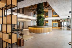 a large lobby with a tree in the center at The Patio Suite Hotel in Albufeira