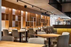 a restaurant with wooden tables and chairs and lights at The Patio Suite Hotel in Albufeira