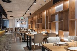 a restaurant with wooden walls and tables and chairs at The Patio Suite Hotel in Albufeira