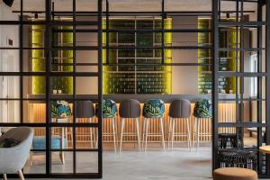 a bar with chairs and a view of a building at The Patio Suite Hotel in Albufeira