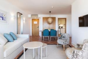 a living room with a couch and a table at The Patio Suite Hotel in Albufeira
