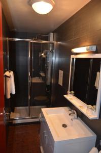 a bathroom with a shower and a sink and a sink at Hôtel Restaurant Panoramique César in Bonnieux +63 photos