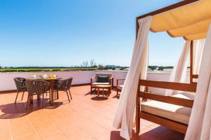 a patio with a table and chairs on a balcony at The Patio Suite Hotel in Albufeira