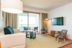 a living room with a couch and a table at The Patio Suite Hotel in Albufeira