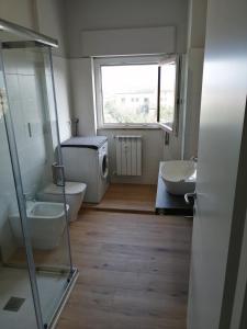 a bathroom with two sinks and a window at Guido's Apartment Villa Romana in Desenzano del Garda