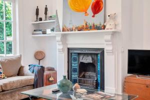 a living room with a fireplace and a tv at Classic Villa Retreat - Steps To Ponsonby Rd in Auckland