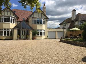 a house with a gravel driveway in front of it at Fring House Bed and Breakfast in Seaton