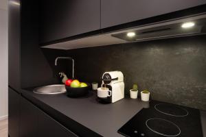 a kitchen counter with a sink and a toaster at CMG Jacques /Pantheon in Paris