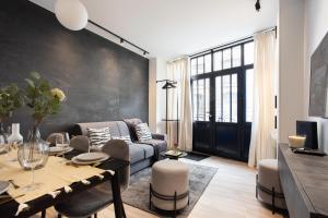 a living room with a couch and a table at CMG Jacques /Pantheon in Paris