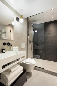 a bathroom with a toilet and a sink and a shower at CMG Jacques /Pantheon in Paris