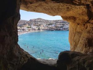 a view of a beach from a window at Fantastic Matala 1 in Matala