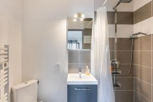 a bathroom with a sink and a shower with a mirror at Studio meublé in Saint-André-de-Sangonis +29 photos