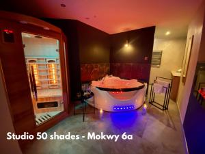 a large bathroom with a tub with lights in it at Sopot Spa Apartament in Sopot