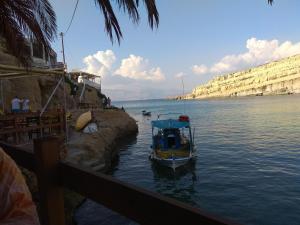 a small boat in a body of water at Fantastic Matala 1 in Matala