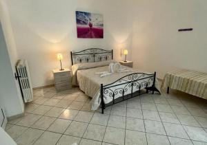 A bed or beds in a room at HOME SALENTO