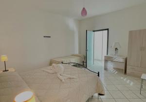 A bed or beds in a room at HOME SALENTO