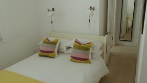 A bed or beds in a room at Little Sussex House