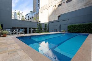 a swimming pool in front of a building at Wyndham Sao Paulo Paulista in São Paulo