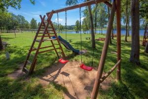 a swing set with a ladder in a park at Domki Bożkowice in Bożkowice