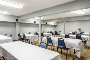 a room with tables and chairs with white table cloths at Quality Inn Branson On the Strip in Branson