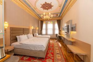 a bedroom with a bed with a coffered ceiling at Blue Gilroy Hotel in Istanbul