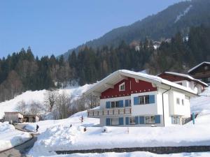 a house with snow on top of a mountain at Ferienwohnung Erhard in Silbertal