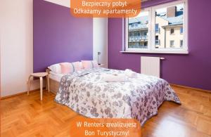 a bedroom with a bed with purple walls and a window at Apartments Warsaw Wyspowa by Renters in Warsaw