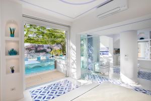 a bathroom with a swimming pool and a tub at Villa Fiorentino in Positano
