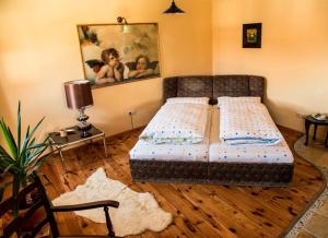 a bedroom with a bed and a table with a lamp at Taverne Vachenlueg in Anger