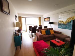 a living room with a couch and a dining room at Hab. Privada con la mejor vista in Tacna