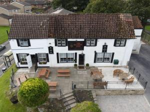 an aerial view of a white house with benches and tables at The Saxon Inn in Bishop Auckland