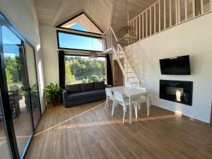 a living room with a white table and a staircase at Casa rural Rio de Cotillas in Cotillas