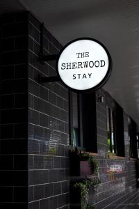 a sign that reads the sherwoodstay hanging on a building at The Sherwood Hotel in Lismore