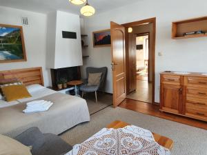 a bedroom with two beds and a desk and a chair at Apartament Iskra in Zakopane
