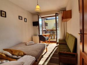 a bedroom with two beds and a balcony at Apartament Iskra in Zakopane