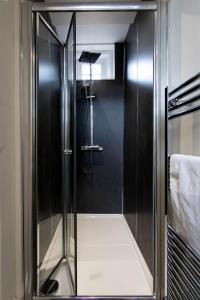 a shower with a glass door in a bathroom at Charter House School Serviced Apartments - Hull Serviced Apartments HSA in Hull